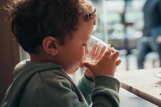 Kid drinking a cup of water