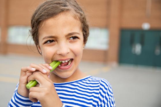 Child eating a vegetable